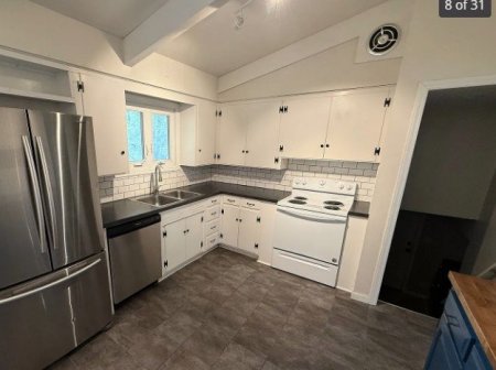 Stairs from Garage_Laundry-Level 1 entering Kitchen_Living Room-Level 1.jpg